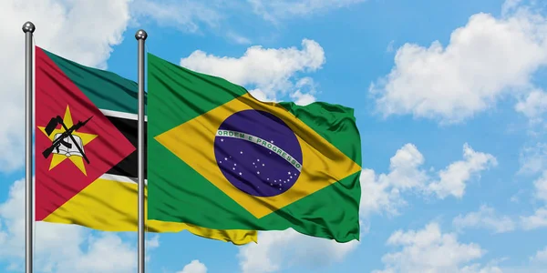 Mozambique and Brazil flag waving in the wind against white cloudy blue sky together. Diplomacy concept, international relations. — Stock Photo, Image