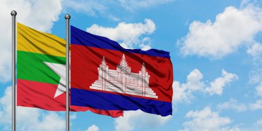 Myanmar ve Kamboçya bayrağı birlikte beyaz bulutlu mavi gökyüzüne karşı rüzgarsal sallayarak. Diplomasi kavramı, uluslararası ilişkiler.
