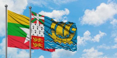 Myanmar ve Saint Pierre ve Miquelon bayrağı birlikte beyaz bulutlu mavi gökyüzüne karşı rüzgarda sallayarak. Diplomasi kavramı, uluslararası ilişkiler.