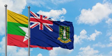 Myanmar ve İngiliz Virgin Adaları bayrağı birlikte beyaz bulutlu mavi gökyüzüne karşı rüzgarda sallayarak. Diplomasi kavramı, uluslararası ilişkiler.