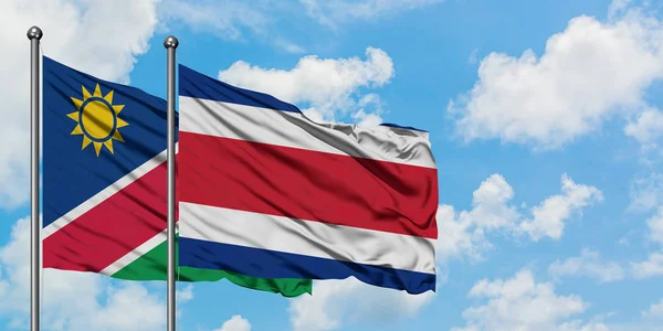 Namibia and Costa Rica flag waving in the wind against white cloudy blue sky together. Diplomacy concept, international relations. — Stock Photo, Image