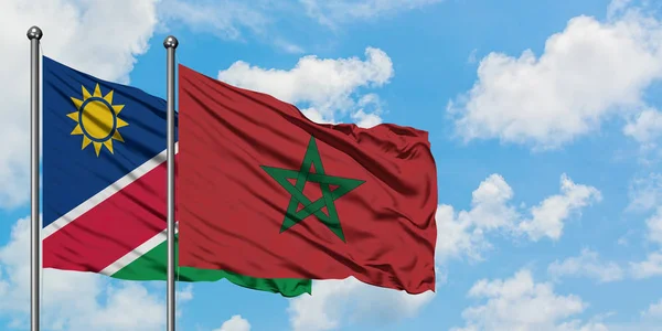 Namibia and Morocco flag waving in the wind against white cloudy blue sky together. Diplomacy concept, international relations.