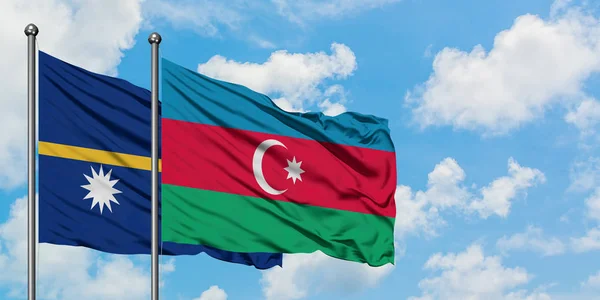 Nauru and Azerbaijan flag waving in the wind against white cloudy blue sky together. Diplomacy concept, international relations.