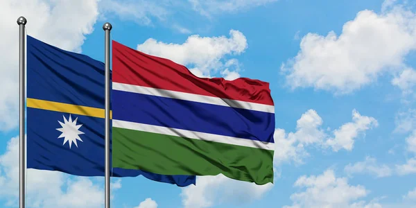 Nauru and Gambia flag waving in the wind against white cloudy blue sky together. Diplomacy concept, international relations. — Stock Photo, Image