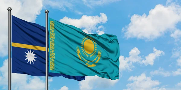 Nauru and Kazakhstan flag waving in the wind against white cloudy blue sky together. Diplomacy concept, international relations. — Stock Photo, Image