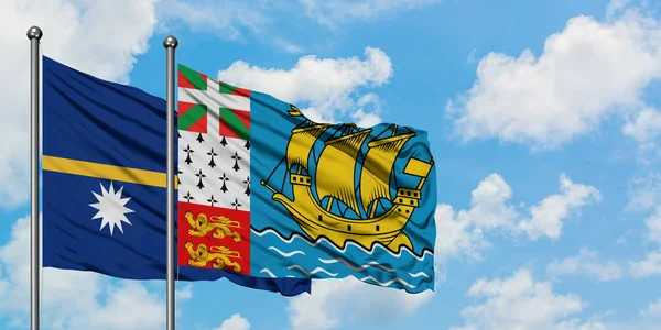 Науру і Сен-П'єр і Мікелон прапор розмахуючи в вітер проти білого хмарного синього неба разом. Концепція дипломатії, міжнародні відносини. — стокове фото