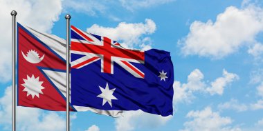 Nepal ve Heard Adası ve Mcdonald Adaları bayrağı birlikte beyaz bulutlu mavi gökyüzüne karşı rüzgarda sallayarak. Diplomasi kavramı, uluslararası ilişkiler.