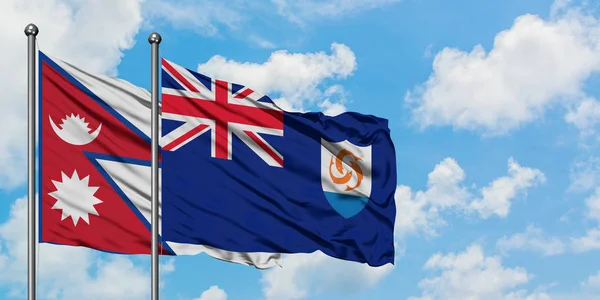 Drapeau du Népal et d'Anguilla agitant dans le vent contre ciel bleu nuageux blanc ensemble. Concept de diplomatie, relations internationales . — Photo