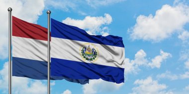 Hollanda ve El Salvador bayrağı birlikte beyaz bulutlu mavi gökyüzüne karşı rüzgarda sallayarak. Diplomasi kavramı, uluslararası ilişkiler.