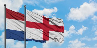 Hollanda ve İngiltere bayrağı birlikte beyaz bulutlu mavi gökyüzüne karşı rüzgarsal sallayarak. Diplomasi kavramı, uluslararası ilişkiler.