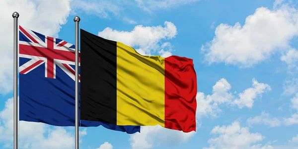 新西兰和比利时国旗在风中飘扬，与白云蓝天相一起。外交概念、国际关系. — 图库照片