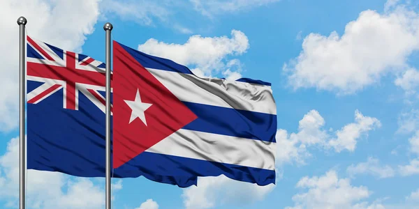 Drapeau de la Nouvelle-Zélande et Cuba agitant dans le vent contre ciel bleu nuageux blanc ensemble. Concept de diplomatie, relations internationales . — Photo