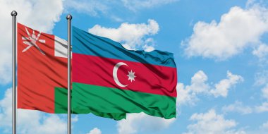 Umman ve Azerbaycan bayrağı havada havada sallanıyor. Diplomasi kavramı, uluslararası ilişkiler.