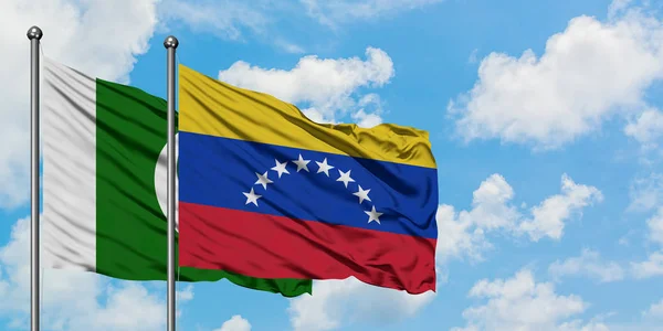 Pakistan and Venezuela flag waving in the wind against white cloudy blue sky together. Diplomacy concept, international relations. — Stock Photo, Image