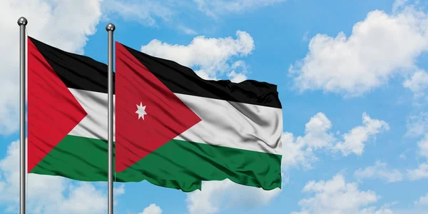 Bandera de Palestina y Jordania ondeando en el viento contra el cielo azul nublado blanco juntos. Concepto diplomático, relaciones internacionales . — Foto de Stock