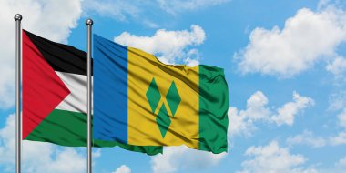 Filistin ve Saint Vincent ve Grenadinler bayrağı birlikte beyaz bulutlu mavi gökyüzüne karşı rüzgarda sallayarak. Diplomasi kavramı, uluslararası ilişkiler.
