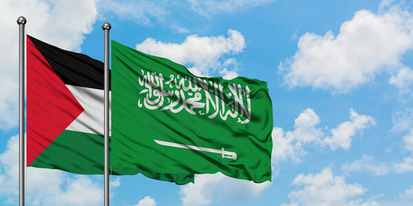 Palestine and Saudi Arabia flag waving in the wind against white cloudy blue sky together. Diplomacy concept, international relations.