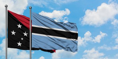 Papua Yeni Gine ve Botsvana bayrağı birlikte beyaz bulutlu mavi gökyüzüne karşı rüzgarda sallayarak. Diplomasi kavramı, uluslararası ilişkiler.