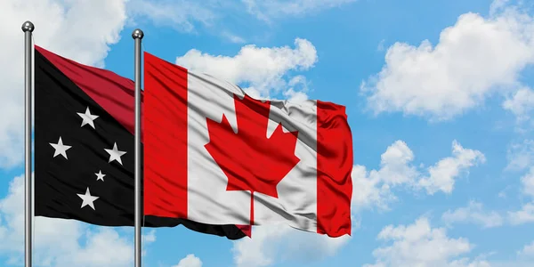 Bandera de Papúa Nueva Guinea y Canadá ondeando en el viento contra el cielo azul nublado blanco juntos. Concepto diplomático, relaciones internacionales . — Foto de Stock