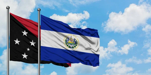 Bandera de Papúa Nueva Guinea y El Salvador ondeando en el viento contra el cielo azul nublado blanco juntos. Concepto diplomático, relaciones internacionales . —  Fotos de Stock