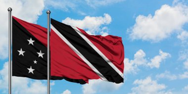 Papua Yeni Gine ve Trinidad ve Tobago bayrağı birlikte beyaz bulutlu mavi gökyüzüne karşı rüzgarda sallayarak. Diplomasi kavramı, uluslararası ilişkiler.