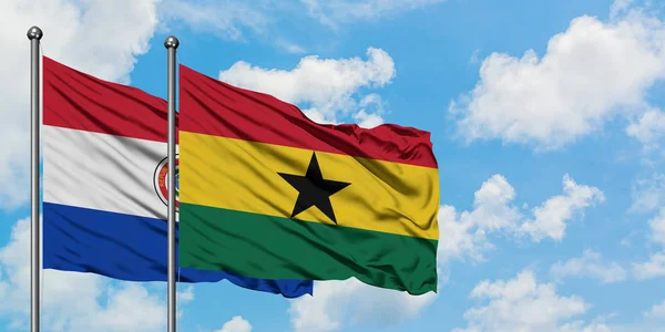 Paraguay and Ghana flag waving in the wind against white cloudy blue sky together. Diplomacy concept, international relations. — Stock Photo, Image