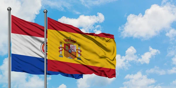 Paraguay and Spain flag waving in the wind against white cloudy blue sky together. Diplomacy concept, international relations. — Stock Photo, Image