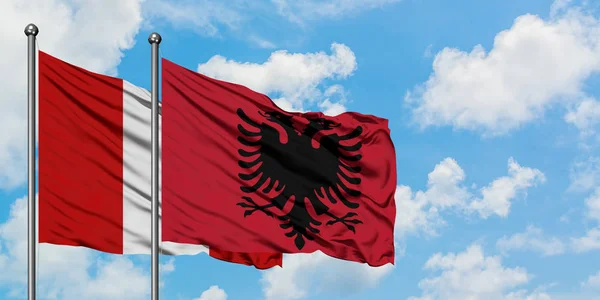 Peru and Albania flag waving in the wind against white cloudy blue sky together. Diplomacy concept, international relations. — Stock Photo, Image