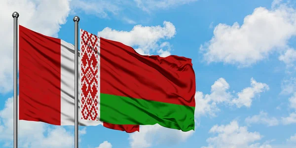 Peru and Belarus flag waving in the wind against white cloudy blue sky together. Diplomacy concept, international relations. — Stock Photo, Image