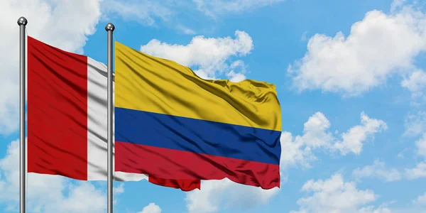 Peru and Colombia flag waving in the wind against white cloudy blue sky together. Diplomacy concept, international relations. — Stock Photo, Image