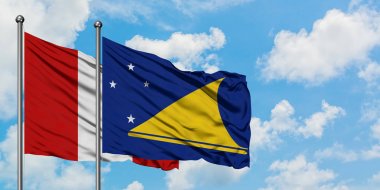 Peru ve Tokelau bayrağı birlikte beyaz bulutlu mavi gökyüzüne karşı rüzgarda sallayarak. Diplomasi kavramı, uluslararası ilişkiler.
