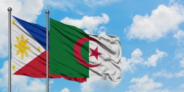 Filipinler ve Cezayir bayrağı birlikte beyaz bulutlu mavi gökyüzüne karşı rüzgarda sallayarak. Diplomasi kavramı, uluslararası ilişkiler.