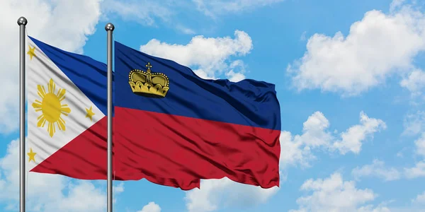 Filipinas e Liechtenstein bandeira acenando no vento contra o céu azul nublado branco juntos. Conceito de diplomacia, relações internacionais . — Fotografia de Stock