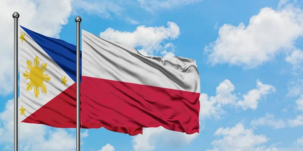 菲律宾和波兰国旗在风中飘扬，白云蓝天相聚。外交概念、国际关系. — 图库照片