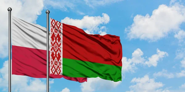 Poland and Belarus flag waving in the wind against white cloudy blue sky together. Diplomacy concept, international relations. — Stock Photo, Image