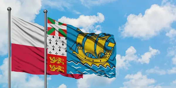 Poland and Saint Pierre And Miquelon flag waving in the wind against white cloudy blue sky together. Diplomacy concept, international relations. — Stock Photo, Image