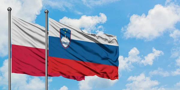 Poland and Slovenia flag waving in the wind against white cloudy blue sky together. Diplomacy concept, international relations. — Stock Photo, Image