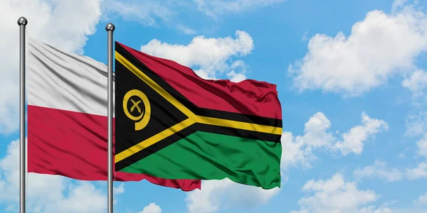 Poland and Vanuatu flag waving in the wind against white cloudy blue sky together. Diplomacy concept, international relations. — Stock Photo, Image
