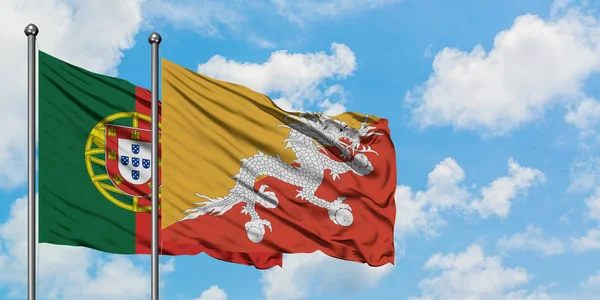 Bandera de Portugal y Bután ondeando en el viento contra el cielo azul nublado blanco juntos. Concepto diplomático, relaciones internacionales . —  Fotos de Stock