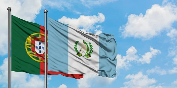 Portogallo e Guatemala sventolano insieme la bandiera contro il bianco cielo blu nuvoloso. Concetto di diplomazia, relazioni internazionali . — Foto Stock