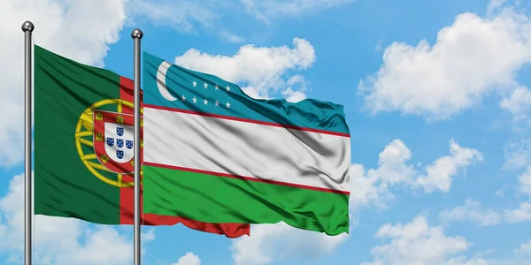 Bandera de Portugal y Uzbekistán ondeando en el viento contra el cielo azul nublado blanco juntos. Concepto diplomático, relaciones internacionales . — Foto de Stock