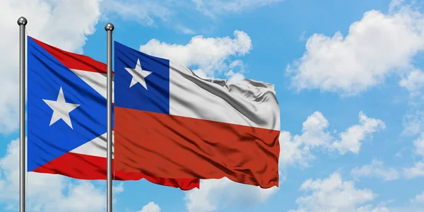 Puerto Rico and Chile flag waving in the wind against white cloudy blue sky together. Diplomacy concept, international relations. — Stock Photo, Image