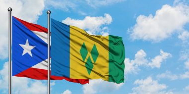 Porto Riko ve Saint Vincent ve Grenadinler bayrağı birlikte beyaz bulutlu mavi gökyüzüne karşı rüzgarda sallayarak. Diplomasi kavramı, uluslararası ilişkiler.