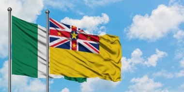 Nigeria and Niue flag waving in the wind against white cloudy blue sky together. Diplomacy concept, international relations.