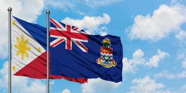 Filipinler ve Cayman Adaları bayrağı birlikte beyaz bulutlu mavi gökyüzüne karşı rüzgarsal sallayarak. Diplomasi kavramı, uluslararası ilişkiler.