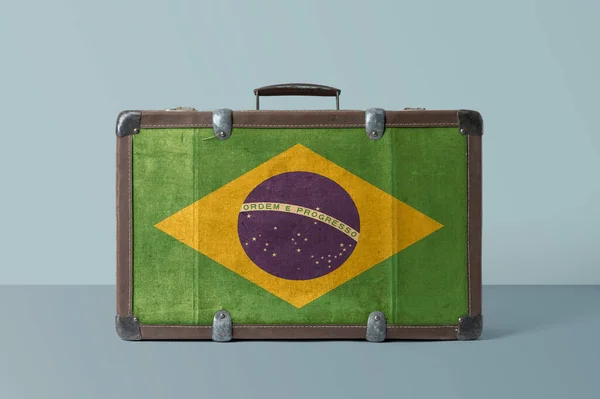 Brazil flag on old vintage leather suitcase with national concept. Retro brown luggage with copy space text.