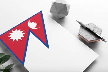 Minimalist kağıt üzerine Nepal bayrağı. Taşın üzerinde zarif bir kalemle ulusal davetiye mektubu. İletişim konsepti.