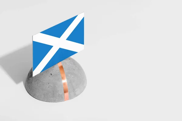 Scotland flag tagged on rounded stone. White isolated background. Side view minimal national concept.