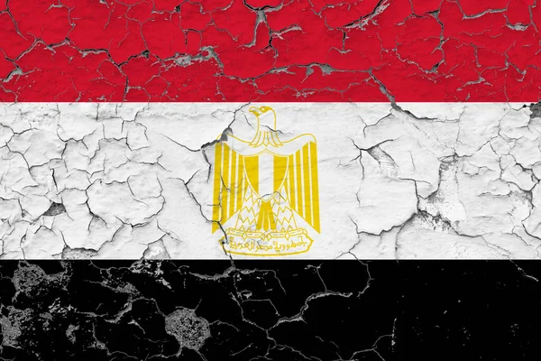 Egypt flag close up grungy, damaged and weathered on wall peeling off paint to see inside surface. Vintage concept.