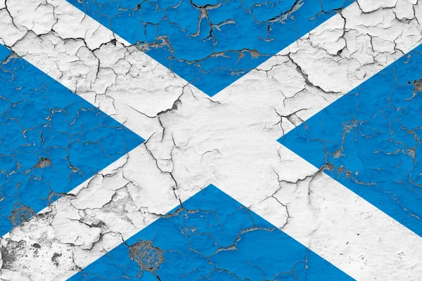 Scotland flag close up grungy, damaged and weathered on wall peeling off paint to see inside surface. Vintage concept.
